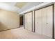Finished basement with carpeted floors, neutral walls, and three large closets at 845 S Kenton St, Aurora, CO 80012