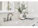 Detailed view of bathroom vanity with modern faucets, quartz counters, and stylish decor at 845 S Kenton St, Aurora, CO 80012