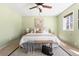 Bright bedroom featuring a cozy bed, bench, and serene green walls at 845 S Kenton St, Aurora, CO 80012