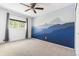 Spacious bedroom with a captivating mural and large window with tree views at 845 S Kenton St, Aurora, CO 80012