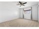 Spacious bedroom featuring neutral carpet, window with curtains, and ceiling fan at 845 S Kenton St, Aurora, CO 80012