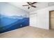 Open bedroom featuring carpet floors, mountain mural, and closet space at 845 S Kenton St, Aurora, CO 80012