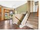 Dining area featuring wood floors, access to the backyard, and a staircase to the upper level at 845 S Kenton St, Aurora, CO 80012