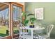 Bright dining area with a white table and chairs, near a window and sliding door at 845 S Kenton St, Aurora, CO 80012
