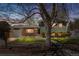 Charming home at twilight featuring a well-maintained front yard, brick accents, and mature tree at 845 S Kenton St, Aurora, CO 80012