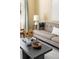 Close-up of a modern living room, showing a gray sofa and dark coffee table at 845 S Kenton St, Aurora, CO 80012