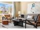 Bright living room with stylish furniture, a black coffee table, and natural light at 845 S Kenton St, Aurora, CO 80012