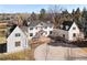 Aerial view of a white home with a circular driveway surrounded by trees at 1 Random Rd, Englewood, CO 80113