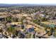 An aerial shot showcasing the property's landscaping, mature trees, and neighborhood streets at 1 Random Rd, Englewood, CO 80113