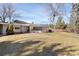 Large backyard with lush grass and an inviting patio area at 1 Random Rd, Englewood, CO 80113