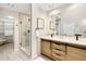 Beautiful bathroom featuring double sinks with granite countertops and a glass enclosed shower at 1 Random Rd, Englewood, CO 80113