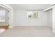 Sunny bedroom with a neutral carpet and a window with outdoor views at 1 Random Rd, Englewood, CO 80113