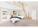 Spacious bedroom featuring high vaulted ceilings, ladder access to loft, and 2 cozy beds at 1 Random Rd, Englewood, CO 80113