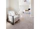 Bedroom featuring neutral color palette, carpeted floor, a cozy sitting chair and plenty of natural light at 1 Random Rd, Englewood, CO 80113