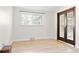 Cozy bedroom with wood floors and a glass-accented door at 1 Random Rd, Englewood, CO 80113