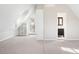 Bright bedroom featuring neutral carpeting, built-in shelving and an en-suite bathroom, illuminated by natural light from the balcony access at 1 Random Rd, Englewood, CO 80113