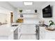 Bright, modern kitchen with white cabinetry, quartz countertops, and stylish decor at 1 Random Rd, Englewood, CO 80113