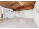 Spacious living room with wood ceiling, light-colored floors and modern track lighting system at 1 Random Rd, Englewood, CO 80113