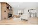 Comfortable living room featuring a stone fireplace, hardwood floors, and natural light with an open layout at 1 Random Rd, Englewood, CO 80113