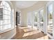 Bright sunroom with hardwood floors, arched window and multiple french doors to outdoor living at 1 Random Rd, Englewood, CO 80113