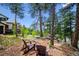 Cozy backyard area featuring wooded seating area and views of the surrounding mountains at 26116 Chief Hosa Rd, Golden, CO 80401