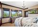 Cozy bedroom with beautiful views, natural light, and decorative fur throw blanket at 26116 Chief Hosa Rd, Golden, CO 80401