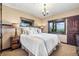 Comfortable bedroom with beautiful views, natural light, and elegant chandelier lighting at 26116 Chief Hosa Rd, Golden, CO 80401