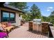 Spacious deck with mountain views and outdoor seating area with built-in grill at 26116 Chief Hosa Rd, Golden, CO 80401