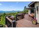 Large deck with dining, grill, mountain views, and outdoor seating at 26116 Chief Hosa Rd, Golden, CO 80401
