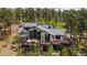 Aerial view of home showcasing large deck and wooded landscaping at 26116 Chief Hosa Rd, Golden, CO 80401