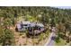 Aerial view of a home with a large deck and wooded surroundings at 26116 Chief Hosa Rd, Golden, CO 80401