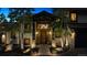 Elegant home exterior at twilight with stone accents, a welcoming entrance, and illuminated landscaping at 26116 Chief Hosa Rd, Golden, CO 80401