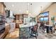Gourmet kitchen with a granite island, modern appliances, and adjacent dining area with scenic views at 26116 Chief Hosa Rd, Golden, CO 80401