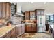 Modern kitchen with granite countertops, stainless steel appliances, and stone backsplash creating a stylish cooking space at 26116 Chief Hosa Rd, Golden, CO 80401
