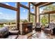Cozy living room featuring a stone fireplace, large windows, and stunning mountain views at 26116 Chief Hosa Rd, Golden, CO 80401