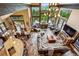 Grand living room boasting a fireplace, high ceilings, floor-to-ceiling windows, and mountain views at 26116 Chief Hosa Rd, Golden, CO 80401
