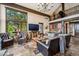 Comfortable living room with stylish furniture, stone accents, and open layout to other living spaces at 26116 Chief Hosa Rd, Golden, CO 80401