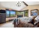 Serene main bedroom featuring picturesque views, a stone fireplace, and a wooden beam ceiling at 26116 Chief Hosa Rd, Golden, CO 80401