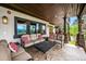 Spacious covered patio with ample seating, stone accents, and scenic mountain views at 26116 Chief Hosa Rd, Golden, CO 80401