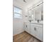 Bathroom featuring double sinks, modern lighting, and sleek black hardware at 691 N Tempe St, Aurora, CO 80018