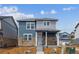 Charming two-story home boasts stone accents, a covered porch, and professional landscaping at 691 N Tempe St, Aurora, CO 80018