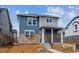 Inviting two-story home with stone accents, charming porch, and well-maintained front yard at 691 N Tempe St, Aurora, CO 80018