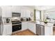 Contemporary kitchen with stainless steel appliances, granite countertops, and light wood flooring at 691 N Tempe St, Aurora, CO 80018
