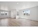 Spacious living room with abundant natural light, freshly painted, and wood-look flooring at 691 N Tempe St, Aurora, CO 80018