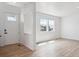 Bright living room with new flooring, fresh white paint, and abundant natural light at 691 N Tempe St, Aurora, CO 80018