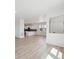 Open-concept living space featuring wood-look floors, neutral paint, and abundant light at 691 N Tempe St, Aurora, CO 80018
