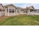 Back of the home with manicured lawn at 9040 Grand Mesa Ave, Longmont, CO 80504