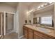 Bathroom with double sinks, a large mirror, and a bathtub/shower combination at 9040 Grand Mesa Ave, Longmont, CO 80504