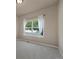 Bright bedroom featuring a large window with sheer curtains and carpeted floor at 9040 Grand Mesa Ave, Longmont, CO 80504