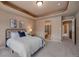 Bedroom featuring a cozy bed, carpeted floor and an ensuite bathroom at 9040 Grand Mesa Ave, Longmont, CO 80504